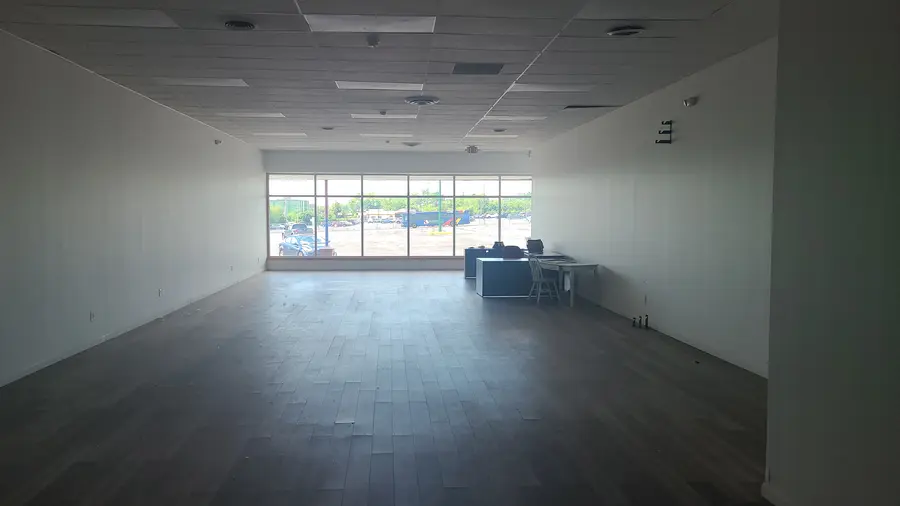 The first desk in place, looking out over the same parking lot from the storefront photo