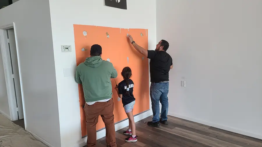 A family effort, putting up the accent wall together